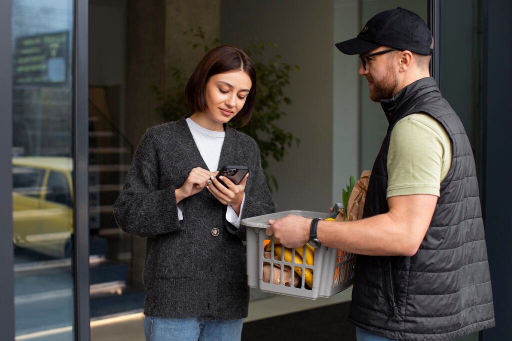 delivery man giving groceries order customer